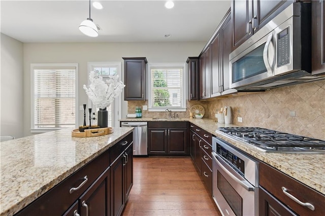 2828 Broughton Ln SE, Atlanta, GA 30339 - kitchen with stainless steel appliances, light stone countertops, dark brown cabinetry, tasteful backsplash, and recessed lighting