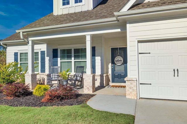 entrance to property with covered porch and a garage