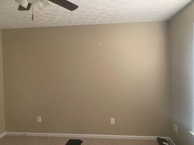 9590 English Ivy Ct, Fortson, GA 31808 - unfurnished room featuring baseboards, a ceiling fan, a textured ceiling, and light carpet