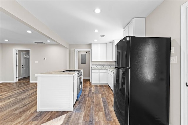 kitchen with black fridge, white cabinetry, stainless steel electric range oven, dark hardwood / wood-style floors, and a kitchen island