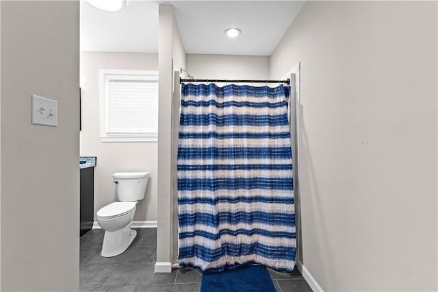 bathroom with tile patterned flooring, curtained shower, and toilet