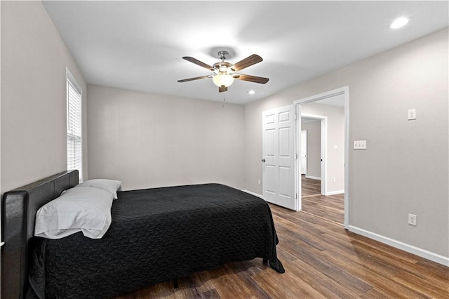 bedroom with ceiling fan and dark hardwood / wood-style floors