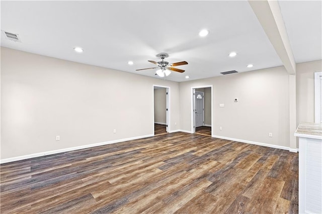 interior space with dark wood-type flooring and ceiling fan