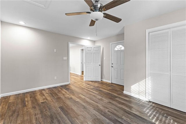 unfurnished bedroom with dark wood-type flooring, a closet, and ceiling fan