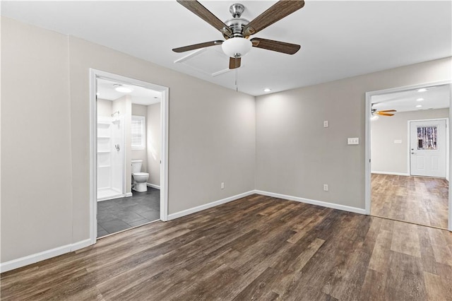 empty room featuring ceiling fan and dark hardwood / wood-style floors