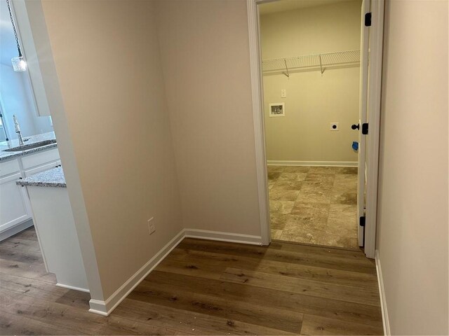 washroom featuring hardwood / wood-style floors, hookup for an electric dryer, sink, and hookup for a washing machine