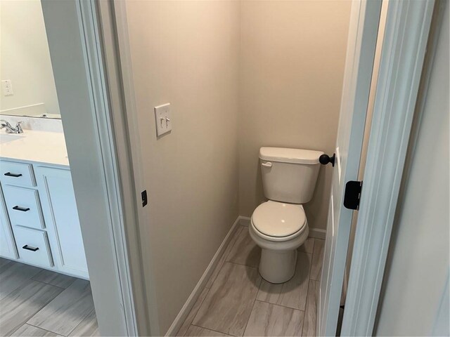 bathroom with toilet and vanity