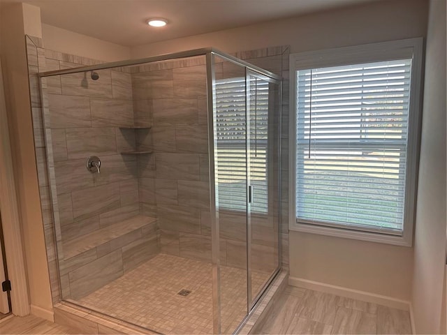 bathroom featuring tile patterned floors, plenty of natural light, and an enclosed shower