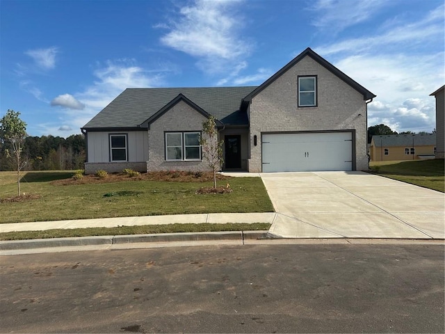 view of front of property with a front yard and a garage