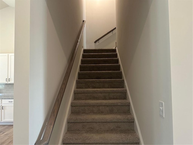 stairs featuring wood-type flooring