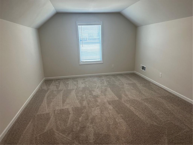 bonus room featuring carpet and vaulted ceiling