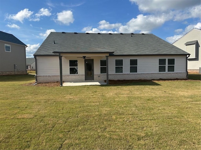 rear view of house featuring a patio, a lawn, and ceiling fan