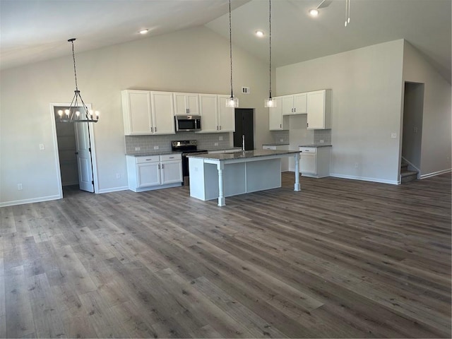 kitchen featuring white cabinetry, stainless steel appliances, dark hardwood / wood-style flooring, and pendant lighting