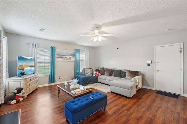 living room featuring ceiling fan, wood finished floors, a textured ceiling, and baseboards