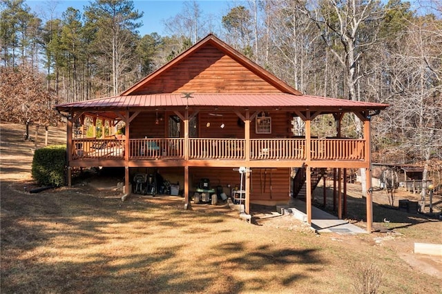 log cabin with a front lawn and a deck