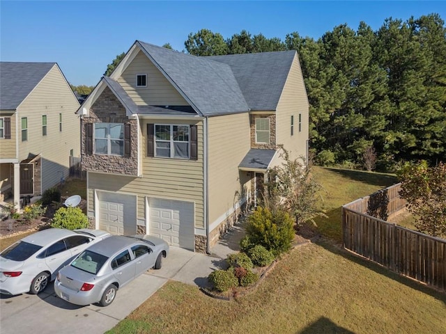view of front of home with a garage, stone siding, concrete driveway, and fence