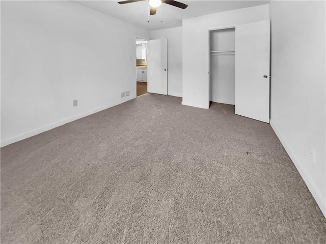 unfurnished bedroom with a closet, dark colored carpet, and ceiling fan