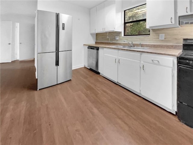 kitchen with light hardwood / wood-style flooring, white cabinetry, sink, and stainless steel appliances