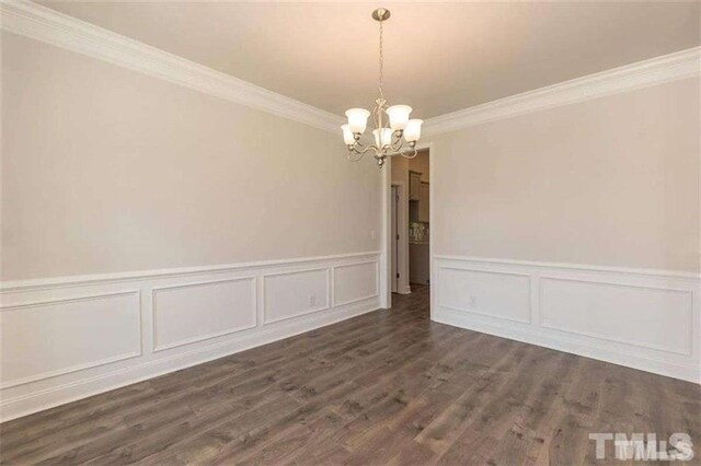 251 Eason St, Bowdon, GA 30108 - unfurnished dining area with a chandelier, ornamental molding, wainscoting, wood finished floors, and a decorative wall