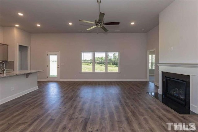 251 Eason St, Bowdon, GA 30108 - unfurnished living room featuring recessed lighting, healthy amount of natural light, a ceiling fan, a fireplace with flush hearth, and baseboards