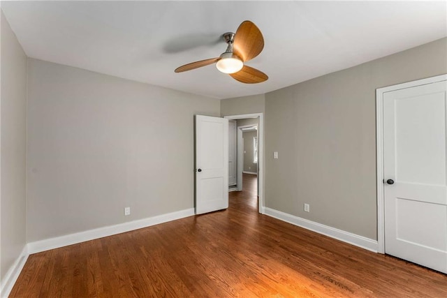 unfurnished bedroom featuring wood finished floors, a ceiling fan, and baseboards