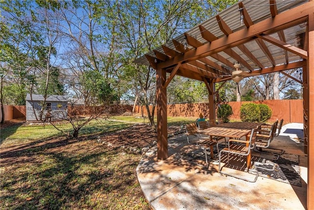 view of yard featuring a fenced backyard, an outdoor structure, a patio area, a shed, and a pergola