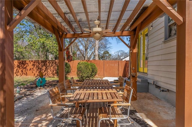 view of patio featuring outdoor dining space, a fenced backyard, a ceiling fan, and a pergola