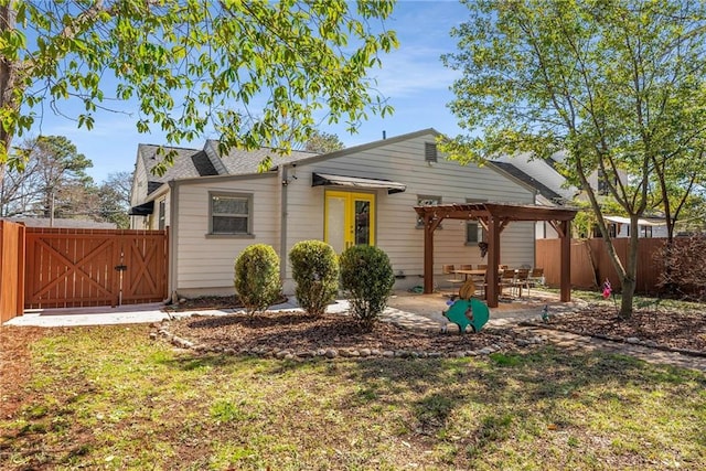 rear view of house featuring a gate, a patio area, fence, and a pergola