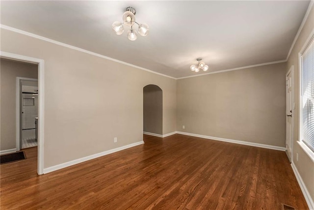 unfurnished room featuring arched walkways, crown molding, wood finished floors, and an inviting chandelier