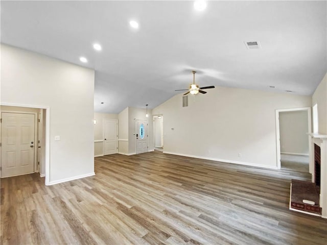 1792 Portwest Way, Hampton, GA 30228 - unfurnished living room featuring ceiling fan, baseboards, wood finished floors, lofted ceiling, and recessed lighting