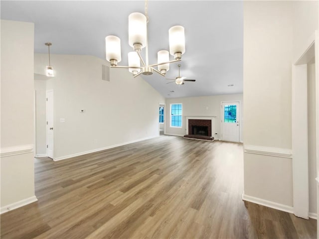 1792 Portwest Way, Hampton, GA 30228 - unfurnished living room featuring ceiling fan, a fireplace, a chandelier, lofted ceiling, and wood finished floors