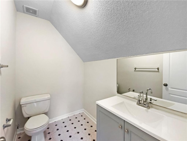 1792 Portwest Way, Hampton, GA 30228 - half bath featuring toilet, lofted ceiling, vanity, baseboards, and a textured ceiling