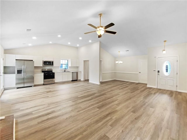 1792 Portwest Way, Hampton, GA 30228 - unfurnished living room featuring vaulted ceiling, ceiling fan, a sink, light wood-style flooring, and recessed lighting