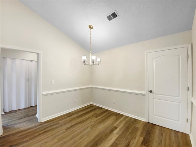 1792 Portwest Way, Hampton, GA 30228 - unfurnished room featuring vaulted ceiling, wood finished floors, a chandelier, and baseboards