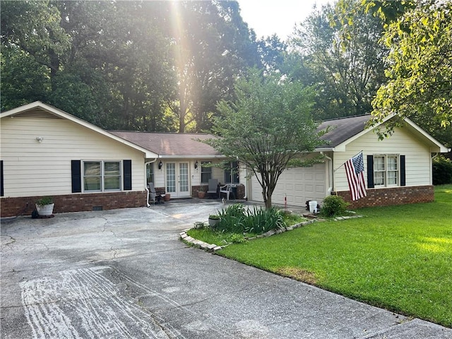 2194 Meadow Dr, Snellville, GA 30078 - ranch-style house with french doors, brick siding, concrete driveway, and a front yard