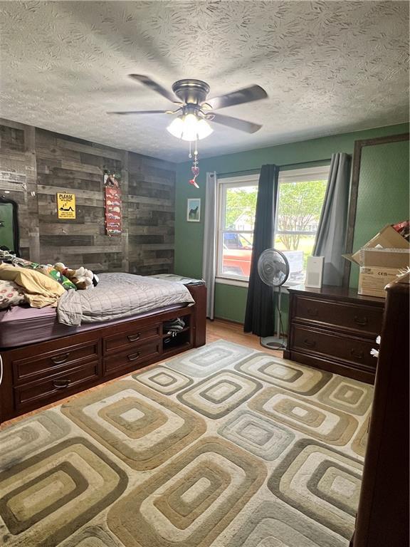 2194 Meadow Dr, Snellville, GA 30078 - bedroom featuring a textured ceiling and a ceiling fan
