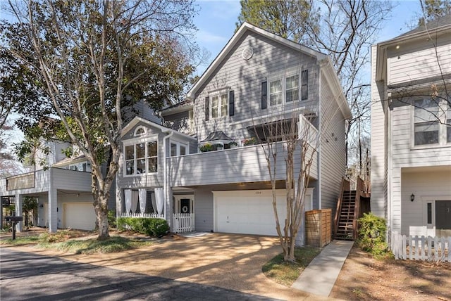 view of front of house featuring stairway, a garage, and driveway