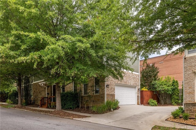 1202 Hardee St NE, Atlanta, GA 30307 - obstructed view of property with concrete driveway and an attached garage