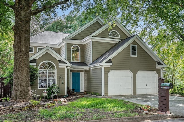 traditional-style home with driveway and a shingled roof