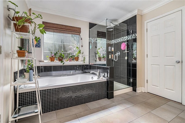 bathroom featuring a stall shower, ornamental molding, a garden tub, and tile patterned floors