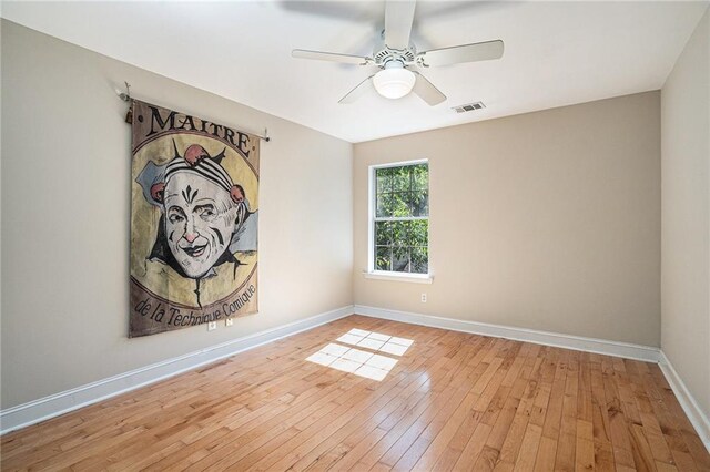 unfurnished room with hardwood / wood-style floors, baseboards, and a ceiling fan