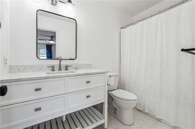 bathroom with toilet, vanity, tile patterned flooring, and a shower with shower curtain