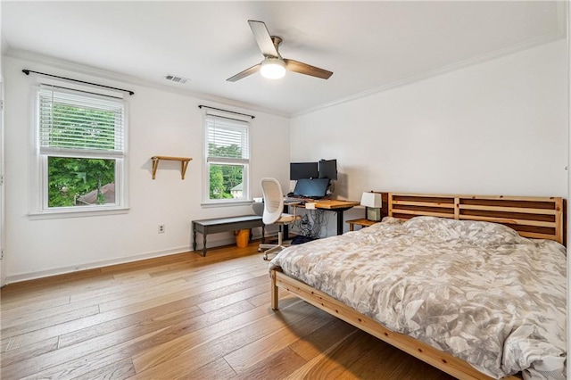 bedroom with ornamental molding, hardwood / wood-style floors, baseboards, an office area, and ceiling fan