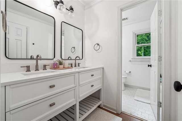 full bathroom featuring baseboards, ornamental molding, toilet, and double vanity