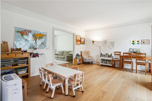 dining room featuring ornamental molding and hardwood / wood-style floors