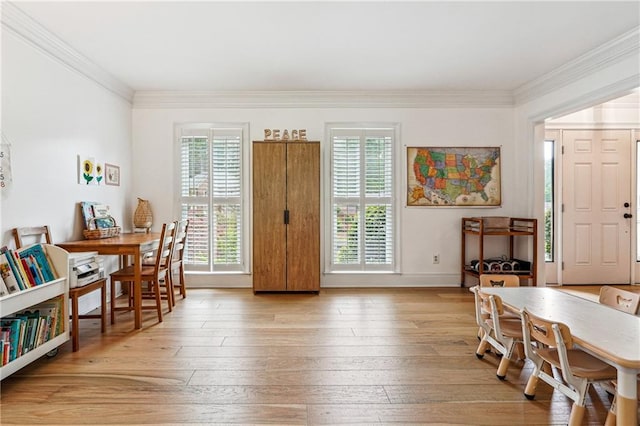 entrance foyer with crown molding, plenty of natural light, light wood finished floors, and baseboards
