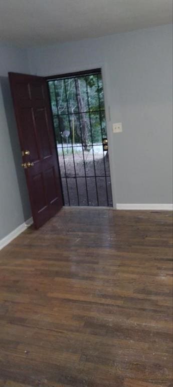 unfurnished room featuring dark wood-type flooring