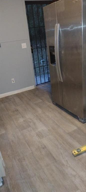 kitchen with stainless steel refrigerator with ice dispenser and wood-type flooring