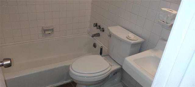 bathroom with toilet, bathtub / shower combination, and tile walls