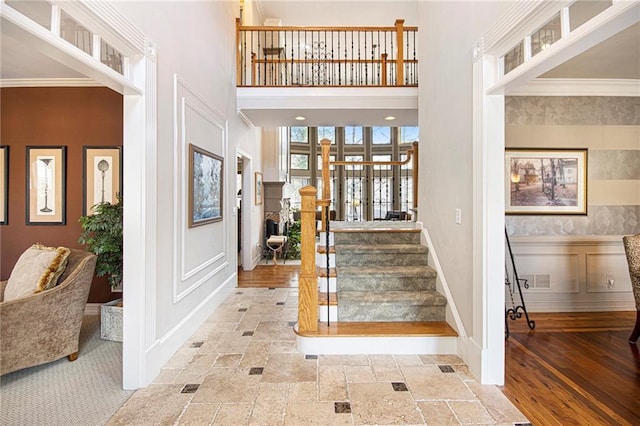 entrance foyer featuring a high ceiling and ornamental molding